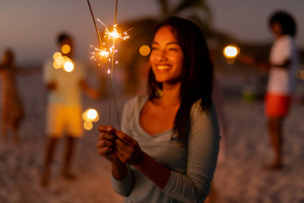 istock Multi-ethnic group of male and female dancing with firework stick 1262254073