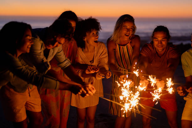 istock Multi-ethnic group of male and female dancing with firework stick 1262255683