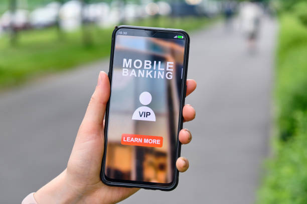 istock Hand holds smartphone with mobile banking interface and click to learn more about VIP status 1262257376