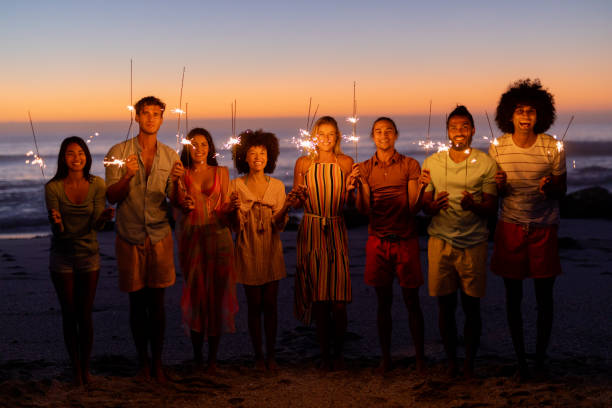 istock Multi-ethnic group of male and female dancing with firework stick 1262257379