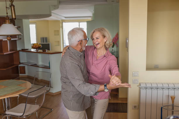 istock Happy Older Man and his Wife are Spending a Nice Time While Dancing at the Home. 1262259549