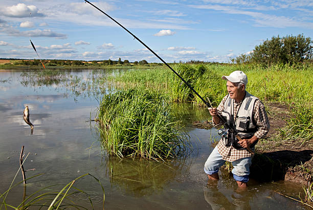 istock fisherman fishing on a river bank 126226599
