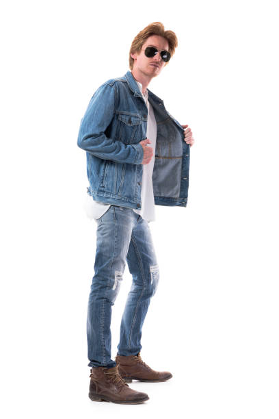 istock Handsome stylish young man trying on denim jeans jacket. Side view. 1262266206
