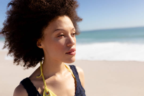 istock Mixed race woman standing on the beach 1262269695