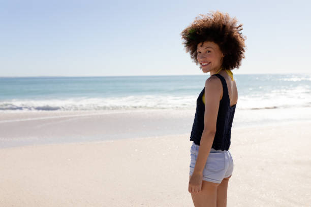 istock Mixed race woman standing on the beach 1262269875