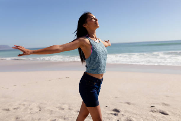 istock Caucasian woman standing on the beach 1262270310