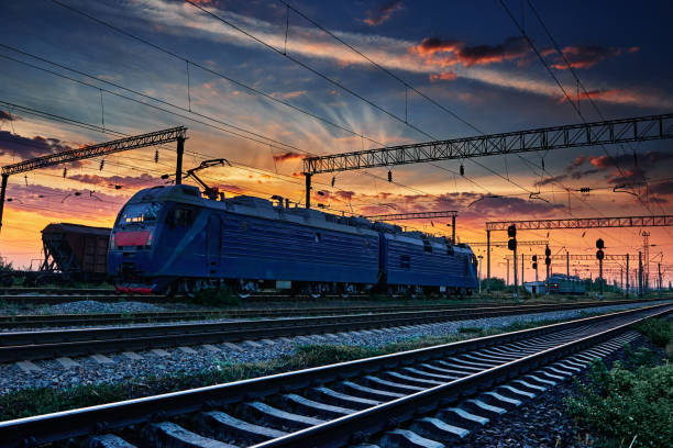 istock railway train and rail cars in a beautiful sunset, dramatic sky and sunlight 1262275121