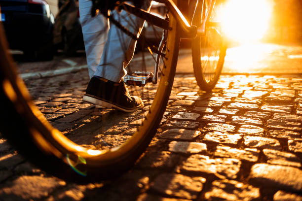 Businessman walking to office taking his bicycle along. Man enjoying while walking to work along with his bike.