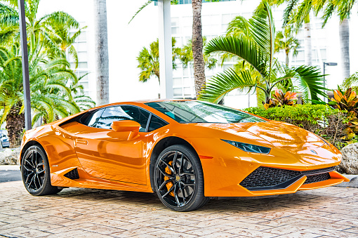 Miami, Florida, USA-February 19, 2016: Supercar Lamborghini Aventador orange color parked next to Ocean drive at South bech at Miami, Florida. Lamborghini is famous expensive automobile brand car