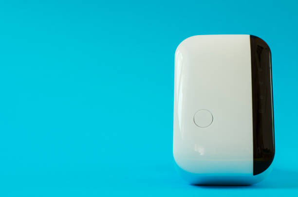 istock Wireless wifi repeater on a blue background close-up 1262282509