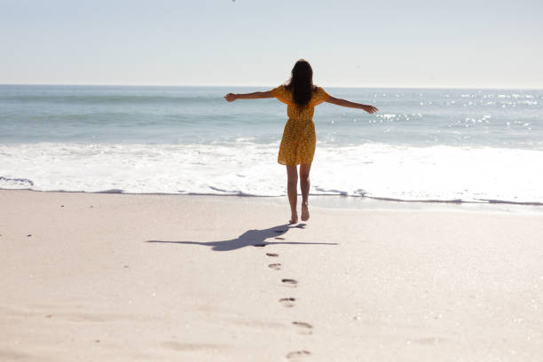 istock Caucasian woman standing on the beach 1262283736