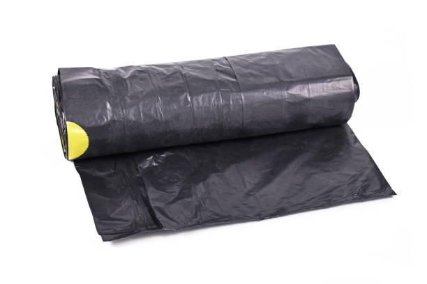 istock Roll of black plastic garbage bags on white background 1262284207