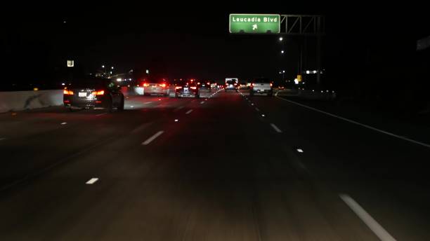 istock View from the car. Los Angeles busy freeway at night time. Massive Interstate Highway Road in California, USA. Auto driving fast on Expressway lanes. Traffic jam and urban transportation concept. 1262285576