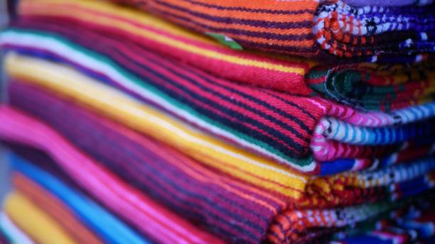 istock Colorful mexican wool serape blankets texture. Woven ornamental vivid textile with authentic latin american pattern. Striped multi colored fabric for poncho and sombrero. Hispanic indigenous style 1262286465