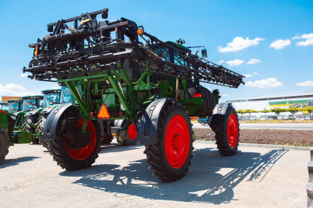 istock Tractor, combine at a field in sunlight. Confident, bright colors 1262286472