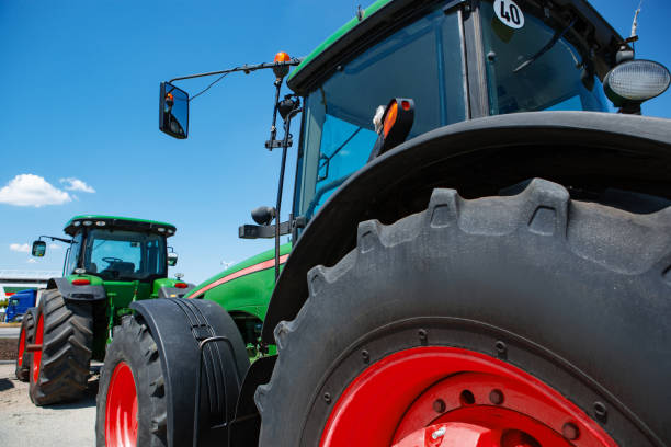 istock Tractor, combine at a field in sunlight. Confident, bright colors 1262286496