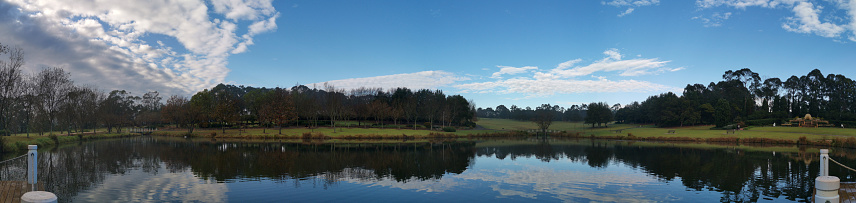Panoramic photo of Deer Creek Reservoir with a view of Mt. Timponogos on a winter day with sunny blue sky