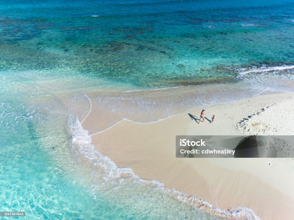 Aerial view of mother and child on Sandy Spit, British Virgin Islands Aerial view of mother and child on Sandy Spit, British Virgin Islands, Caribbean Family Stock Photo