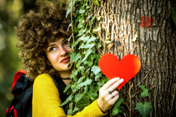 istock Closeup hands of woman hugging tree with heart shape, copy space. 1262289385