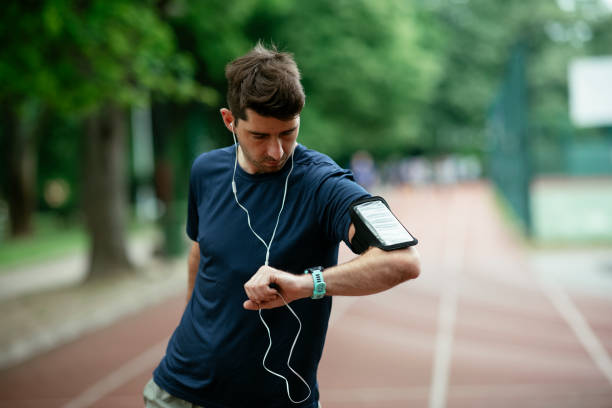 istock Young man checking his heart rate during work out. Young man exercising on the athletics track 1262289726