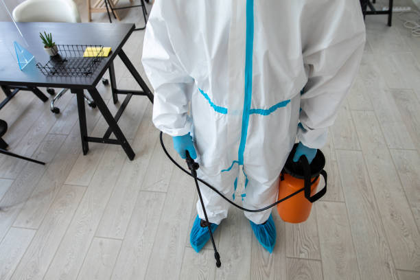 istock Man in protective suit preparing to disinfecting bank office 1262291672