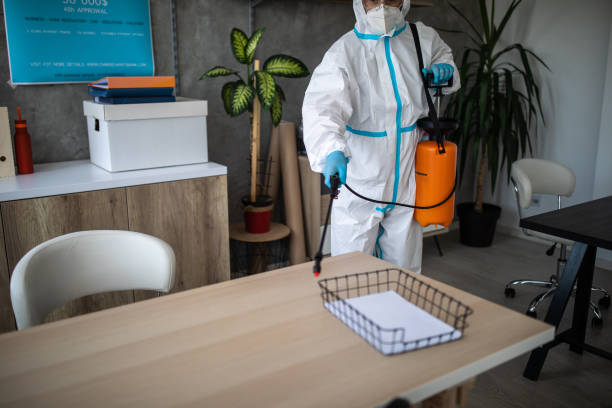 istock Man in protective suit doing decontamination of bank workspace 1262291691