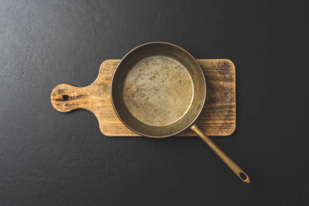 istock Frying pan on wooden board. Top view 1262291865