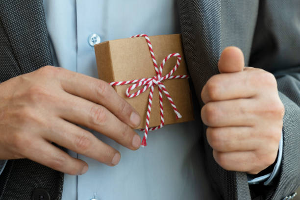 istock Businessman giving Gift Box 1262291977