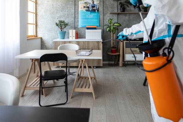 istock Man in protective suit doing decontamination of bank workspace 1262292595