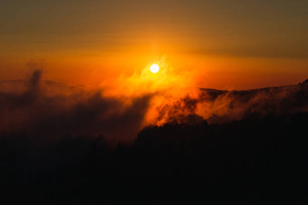 istock sunset between mountains and fog 1262293304