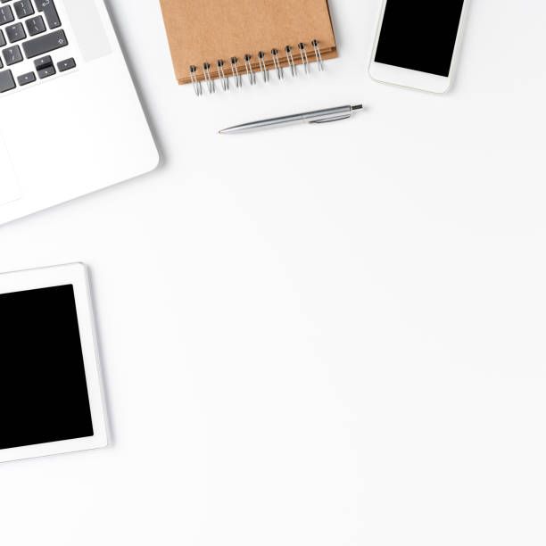istock Business background with laptop and accessories. Office desktop with copyspace 1262294184