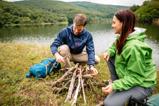 istock Couple making a campfire in nature 1262294361