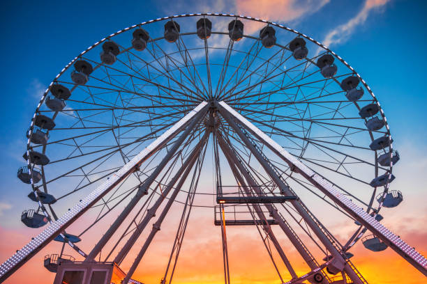 istock Ferris Wheel with sunset sky and clouds 1262294386