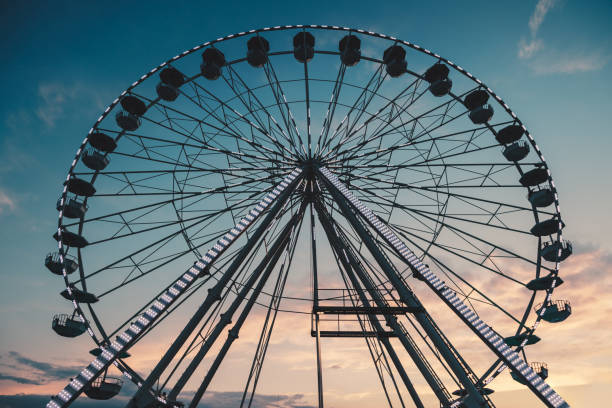 istock Ferris Wheel with sunset sky and clouds 1262294457