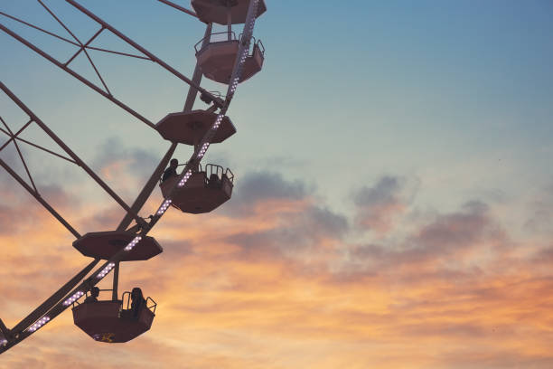 istock Ferris Wheel with sunset sky and clouds 1262294647
