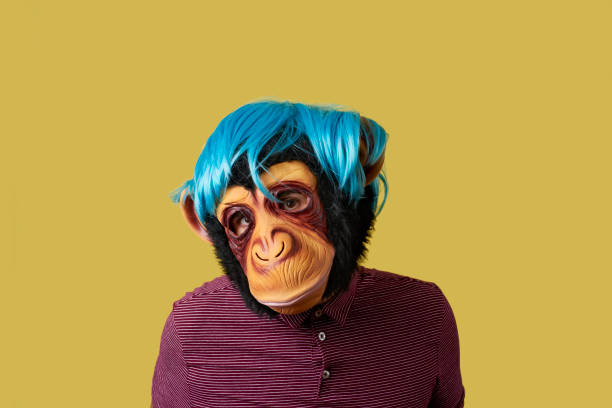 istock man wearing a monkey mask and a wig 1262294841