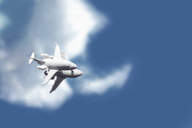 istock A white toy plane stands on a mirror that reflects a blue sky with clouds 1262294843