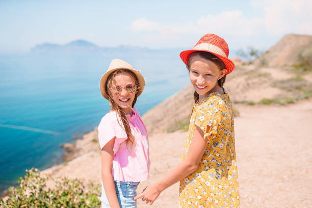 istock children on vacation on white rock background 1262295649