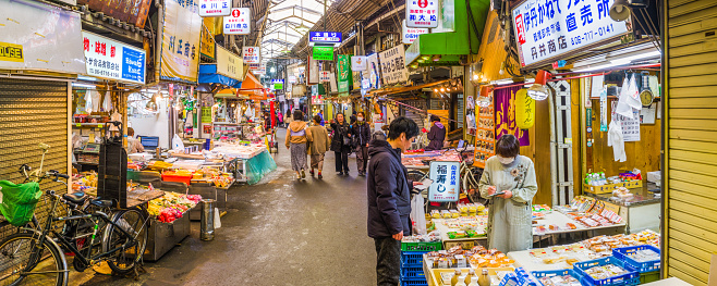 Shoppers and vendors in a covered shopping street in the Namba district of central Osaka, Japan’s vibrant second city.