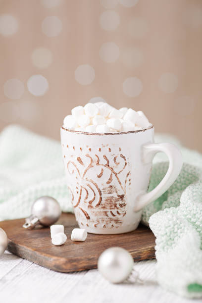 istock Mug with coffee and marshmallow, sweater, cinnamon. Cozy christmas composition. Hygge concept Soft focus 1262301116
