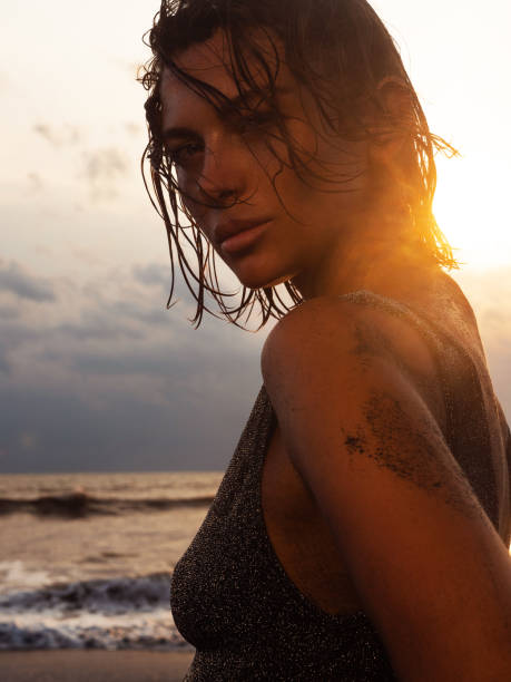 istock Beautiful woman enjoying sun on the beach 1262301190