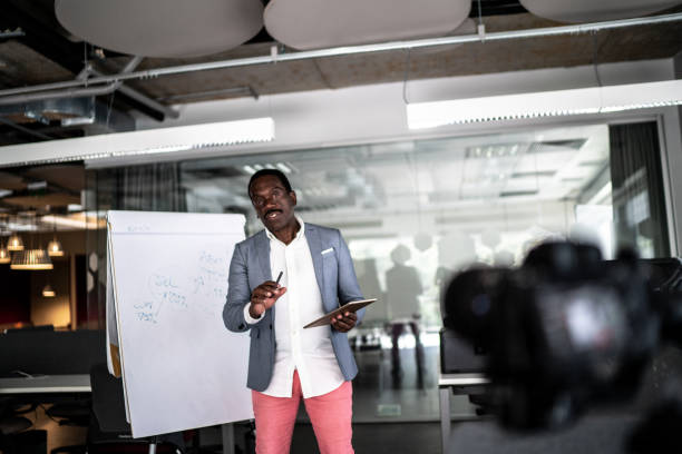 istock Businessman recording a video in the office 1262302185