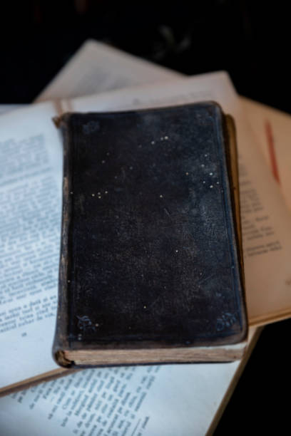 istock Old holy Bible and books on wooden table 1262302338