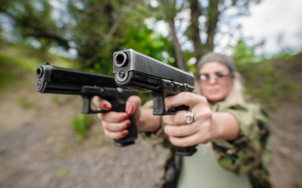 istock Soldier woman with two gun. Gun point aim to attacker 1262302922