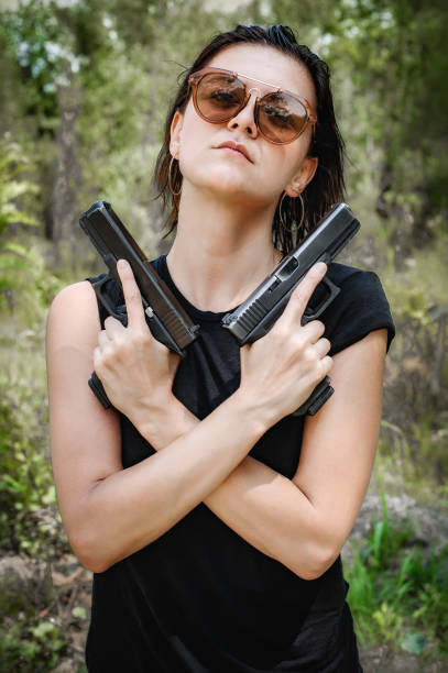 istock Soldier woman with two gun. Gun point aim to attacker 1262303845