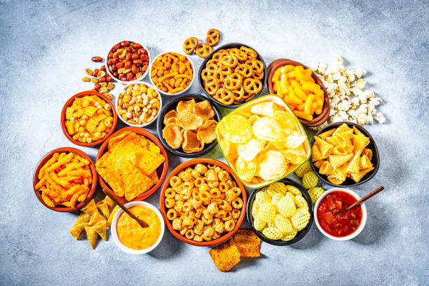istock Salty snacks assortment shot from above on abstract gray table 1262304092