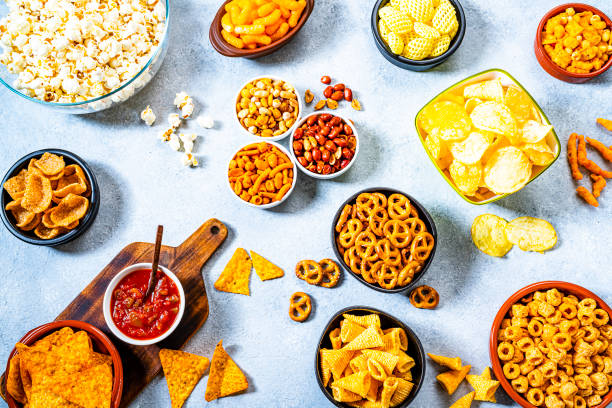 istock Party table with salty snacks shot from above on gray table 1262304152