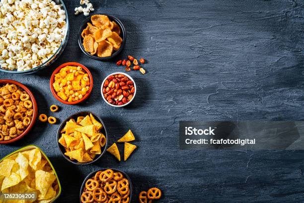 Salty Snacks Assortment Shot From Above On Dark Slate Table Copy Space Stock Photo - Download Image Now