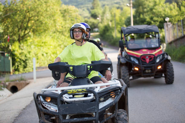 istock Friends in off-road vehicle driving through forest 1262304597