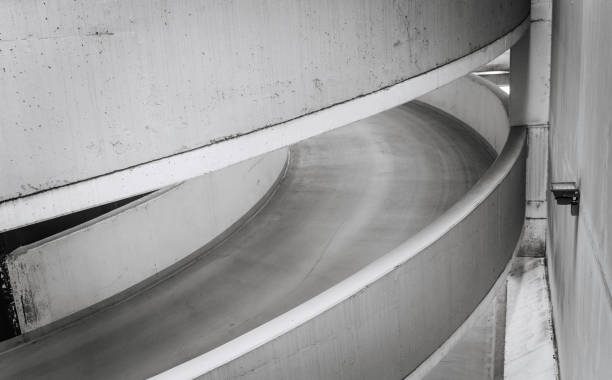 istock Empty underground garage inteior with concrete wall and floor 1262306307